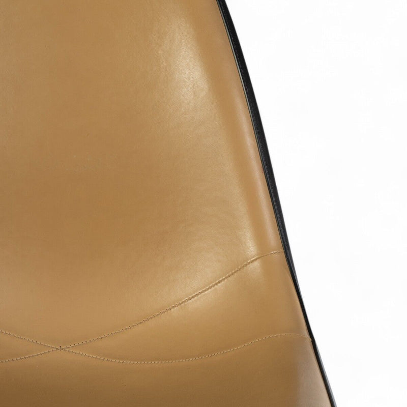 Partial close up front view of beige Eames DSR
