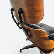 Close up rear right side view of black and walnut Eames Lounge Chair