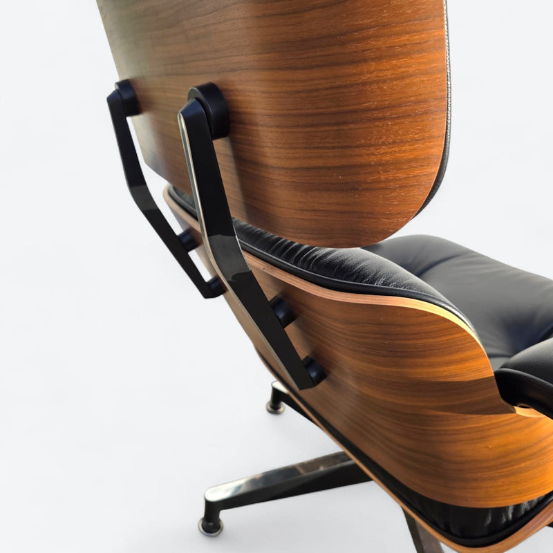 Close up rear right side view of black and walnut Eames Lounge Chair