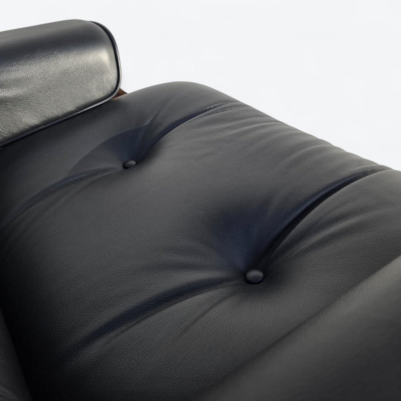 Close up view of seat cushion on black and walnut Eames Lounge Chair