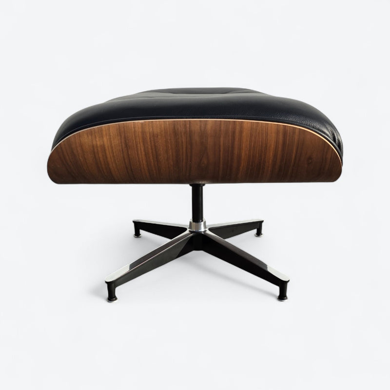 Side view of black and walnut Eames Lounge Chair Ottoman