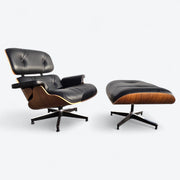 Angled front right side view of black and walnut Eames Lounge Chair and Ottoman