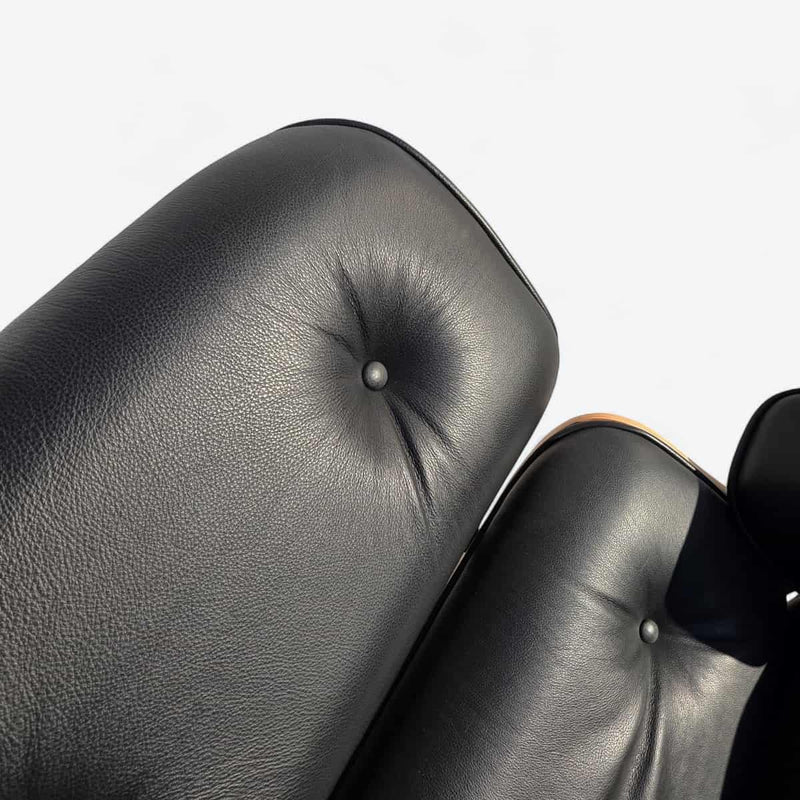 View of back rest cushion on black and oak tall Eames Lounge Chair