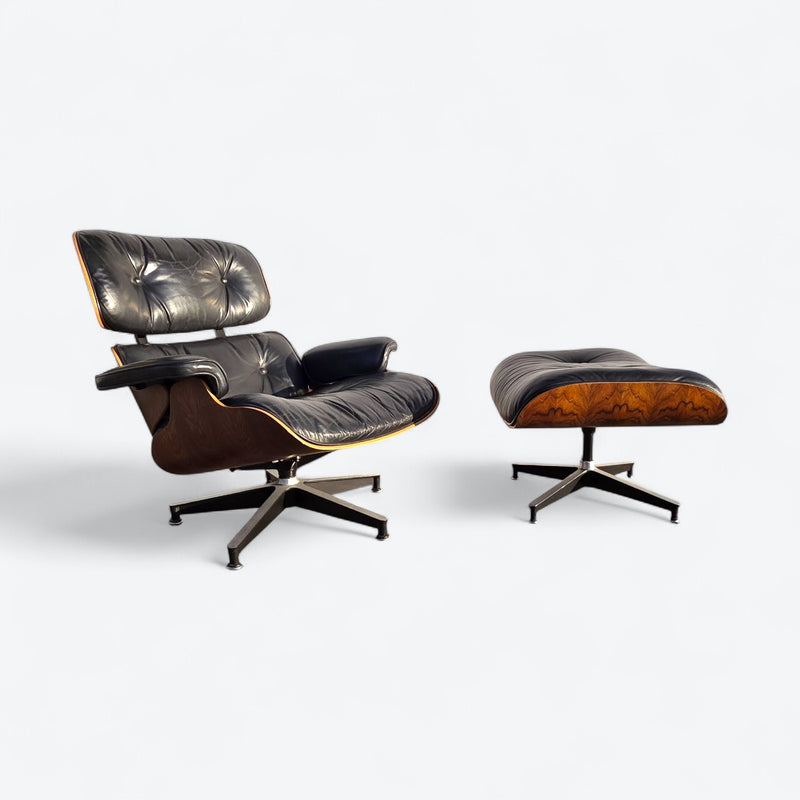 Angled right side view of black and rosewood Eames lounge chair and ottoman