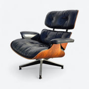 Front left angled view of black and rosewood Eames lounge chair
