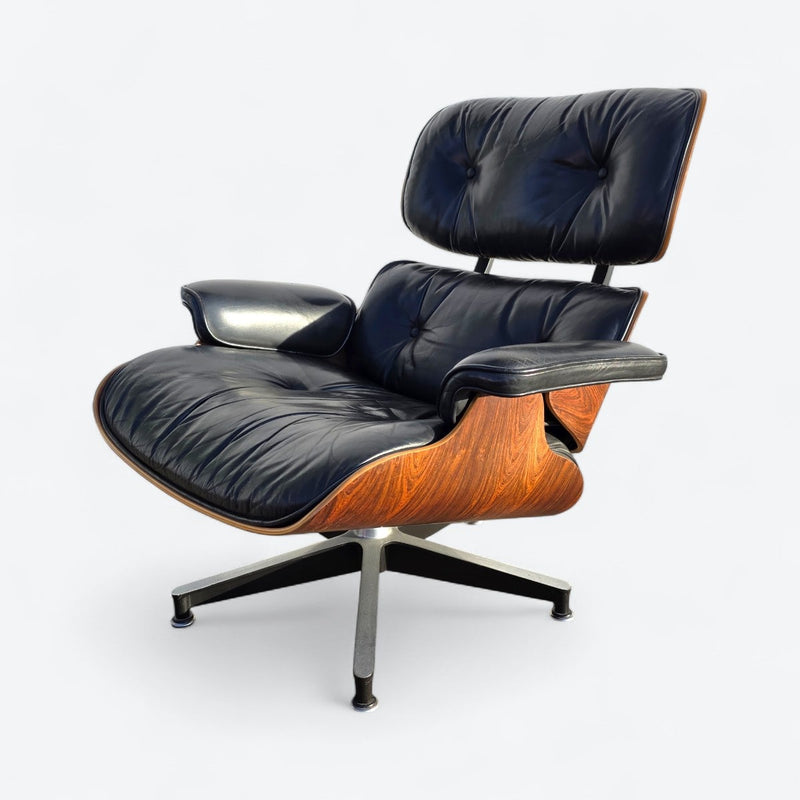 Front left angled view of black and rosewood Eames lounge chair