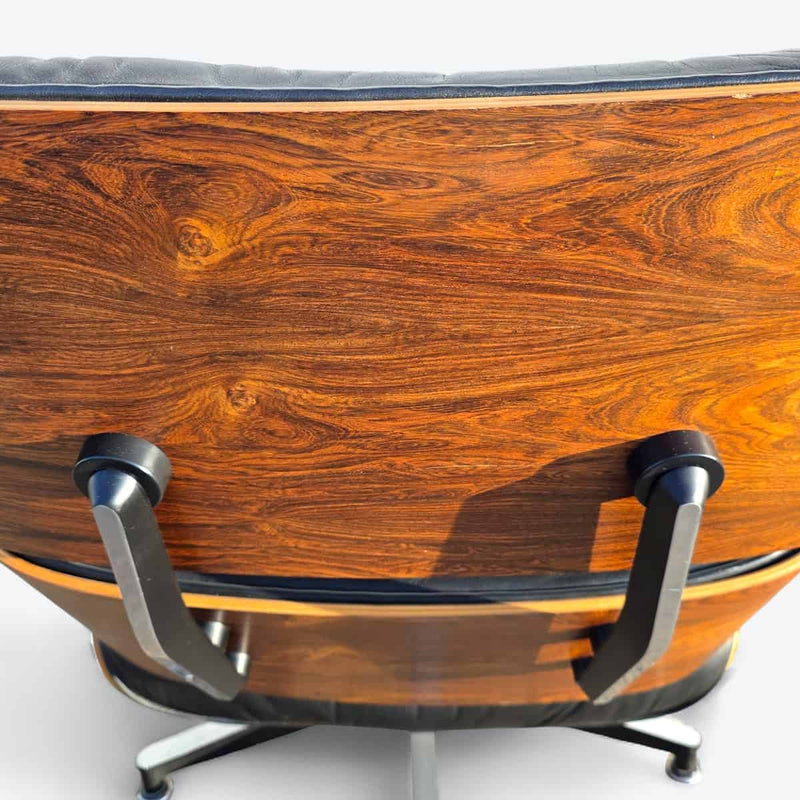 Close up rear view of black and rosewood Eames lounge chair