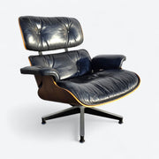 Front right angled view of black and rosewood Eames lounge chair