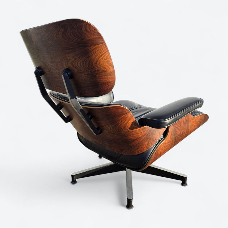 Rear right angled view of black and rosewood Eames lounge chair