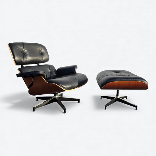 Front angled view of black and cherry Eames Lounge Chair and Ottoman