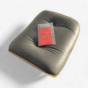 Top down view of grey and oak Eames Lounge Chair Ottoman with label