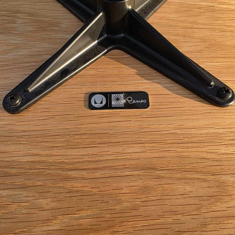 View of label on grey and oak Eames Lounge Chair and Ottoman