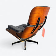 Rear left angled view of black and santos tall Eames Lounge Chair