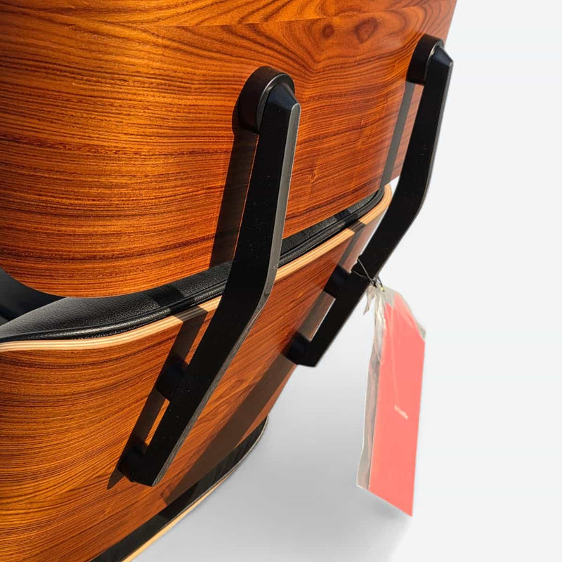 Close up rear angled view of black and santos tall Eames Lounge Chair