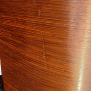 Close up view of wood on black and walnut Eames Lounge Chair