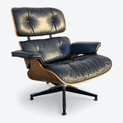 Front right side view of black and walnut Eames Lounge Chair