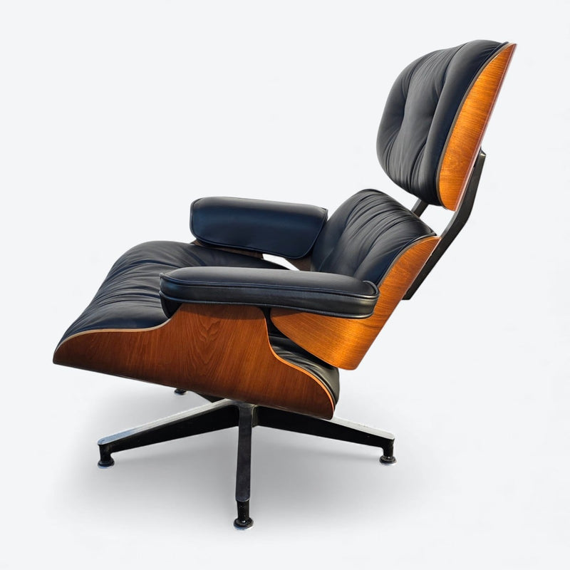 Left side view of black and walnut Eames Lounge Chair