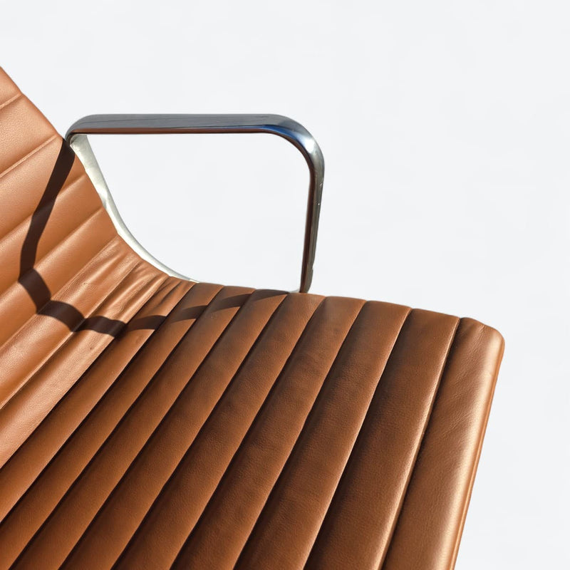 Close up view of leather on tan Eames EA335 office chair