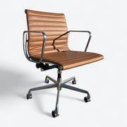 Front right angled view of tan Eames EA335 office chair