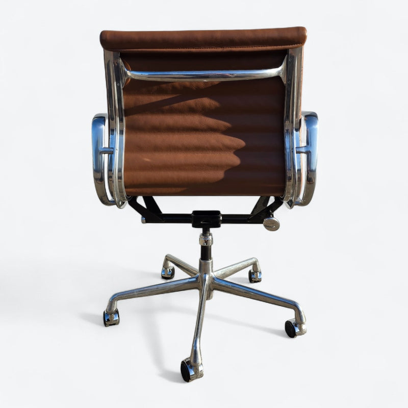 Rear view of tan Eames EA335 office chair