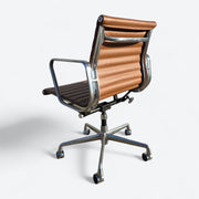 Rear right angled view of tan Eames EA335 office chair