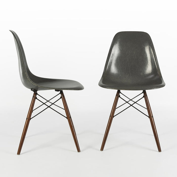 View of pair of Elephant Grey Eames DSW Dining Side Chairs, one from right side, one from front