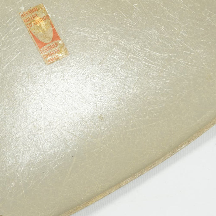 View of label on grey yellow Eames Side Chair on a white background