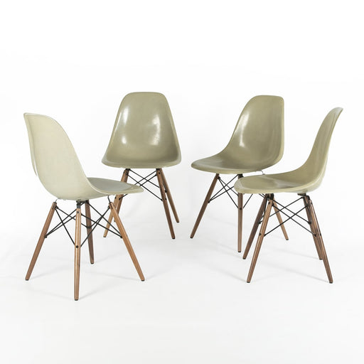 View of 4 Grey Yellow Eames Side Chairs in a circle on a white background