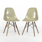 View of pair of grey yellow Eames Side Chairs on a white background