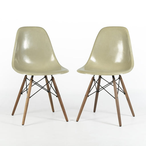 View of pair of grey yellow Eames Side Chairs on a white background