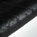 Close up view of black leather Maralunga sofa