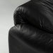 Close up view of corner of black leather Maralunga sofa