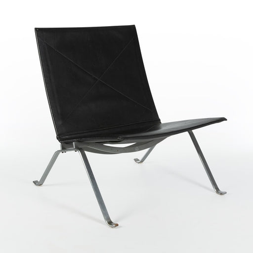 Front angled view of black leather Kjaerholm PK22 lounge chair