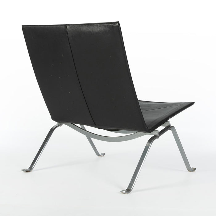 Rear angled view of black leather Kjaerholm PK22 lounge chair
