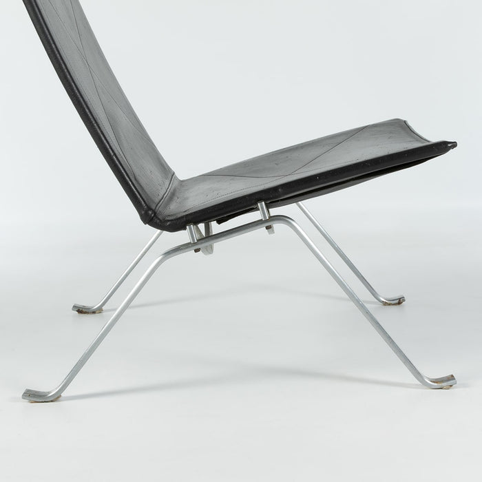 Close up right side view of black leather Kjaerholm PK22 lounge chair