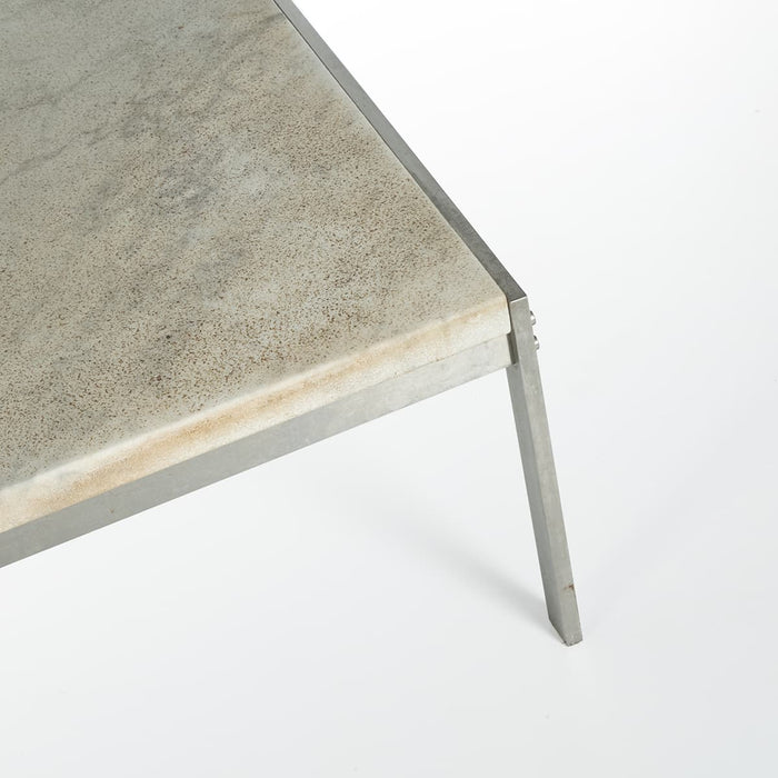 Angled corner view of white marble Kjaerholm PK63 coffee table