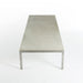 Top down end on view of white marble Kjaerholm PK63 coffee table