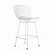 Rear angled view of white Bertoia barstool