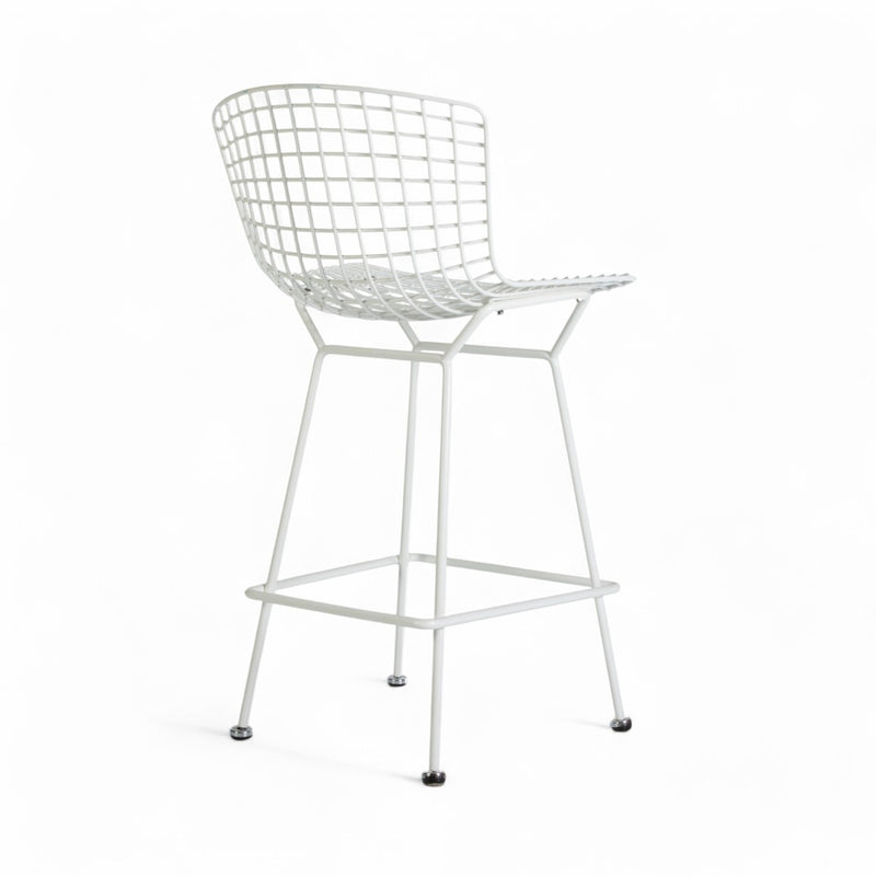 Rear angled view of white Bertoia barstool
