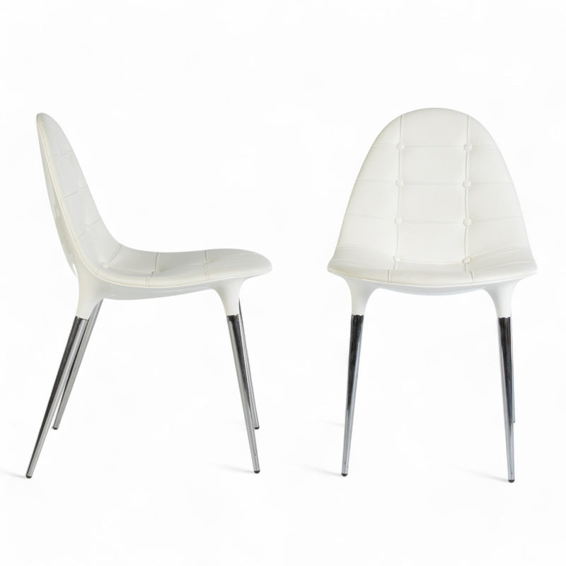View of pair of Cassina Starck Caprice chairs, one from right side, one from front