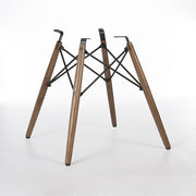 Rear angled view of walnut Eames dowel base